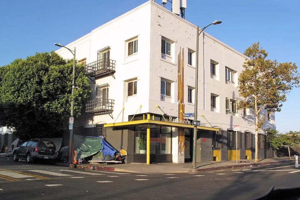 White three-story brick single-room occupancy hotel in downtown Los Angeles, California.